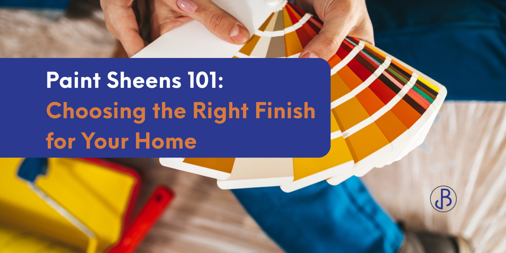 Person holding a paint color swatch booklet to choose paint sheens for an interior project, with painting tools in the background.