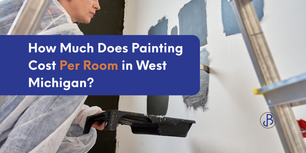 Person in protective clothing paints wall gray; text overlay reads, "Painting Cost Per Room in West Michigan?" with paint samples and a ladder visible, highlighting key factors that influence painting cost per room.