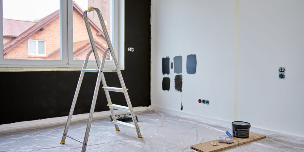 White wall in progress with paint swatches showing different colors for a painting cost per room project.