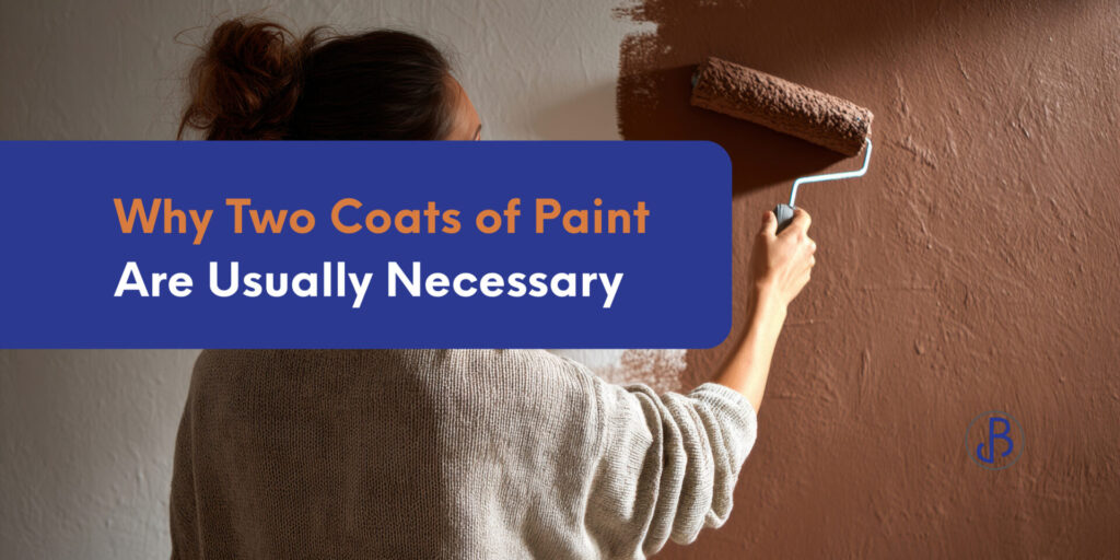 A person uses a paint roller to apply brown paint on a wall. Text overlay reads: "Why applying two coats of paint is usually necessary.